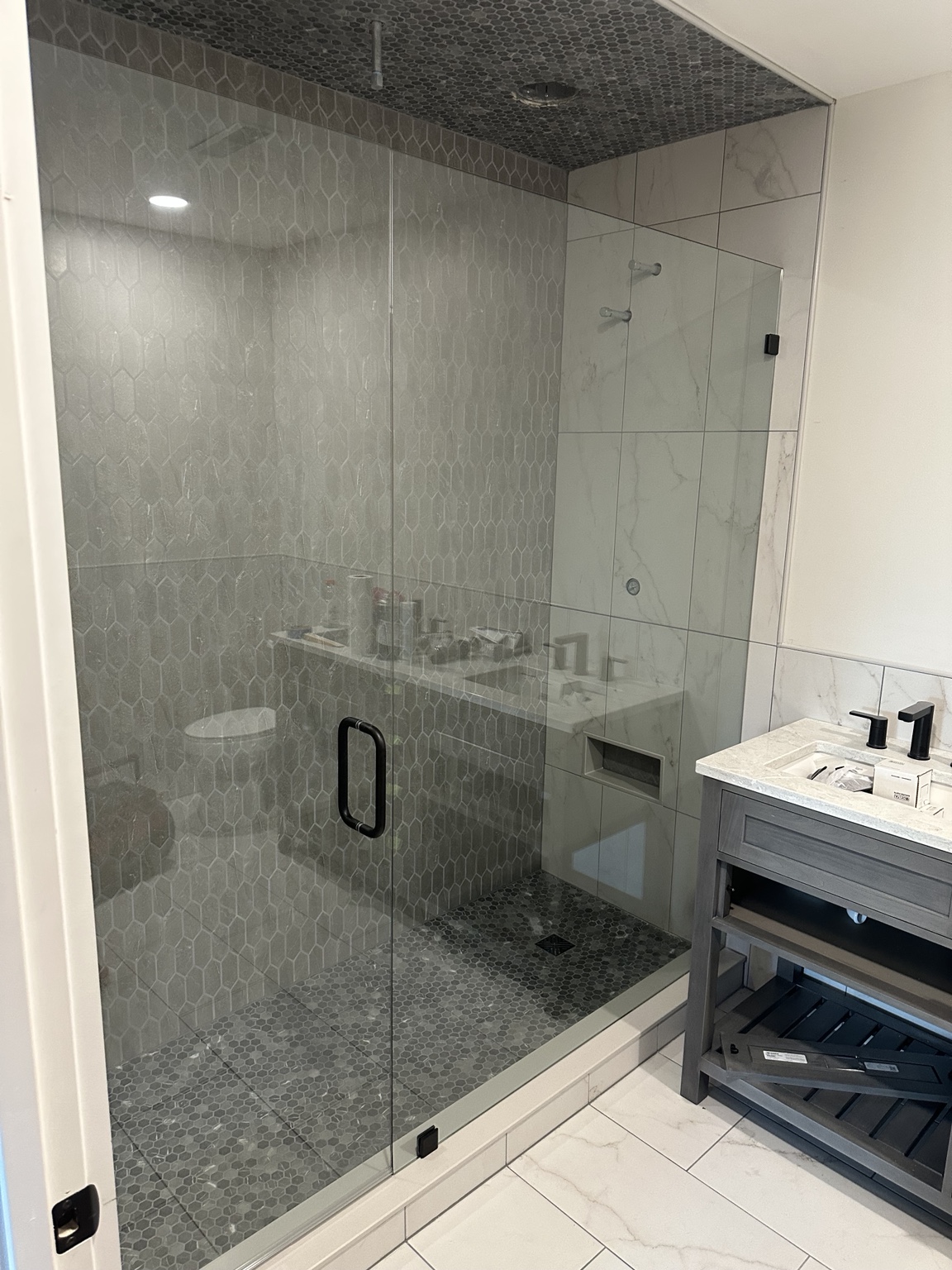 Frameless shower with black hardware